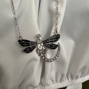 Stunning jeweled dragonfly pendant with black enamel on a silver necklace